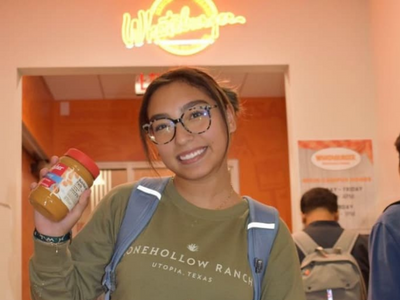 Student holding peanut butter